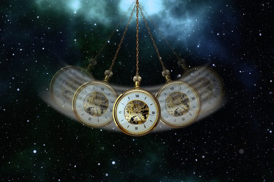 Swinging gold pocket watch against a starry sky